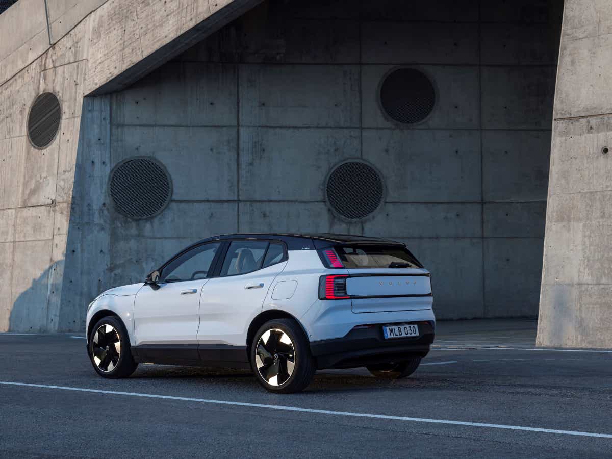Rear three-quarter of a cold blue Volvo EX30
