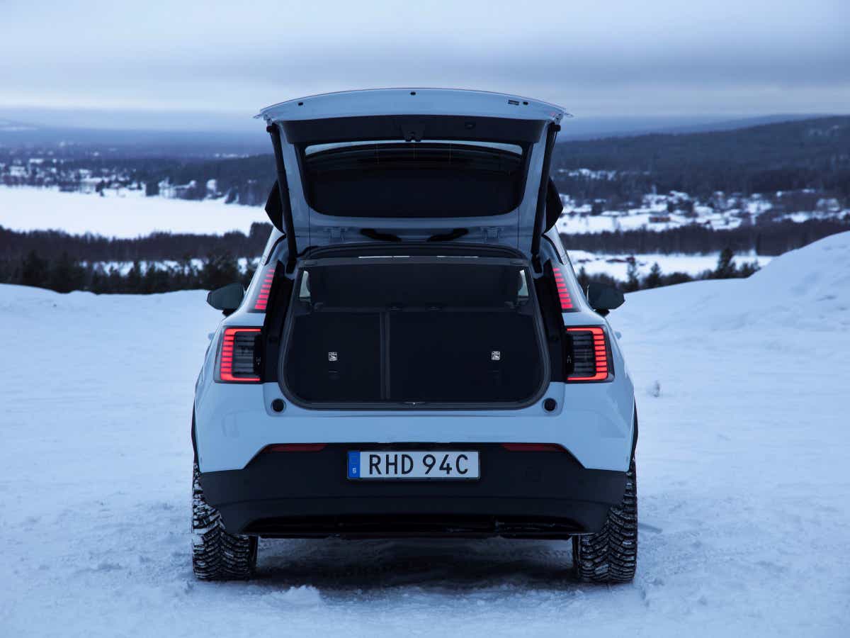 Rear view with open boot of a cold blue Volvo EX30