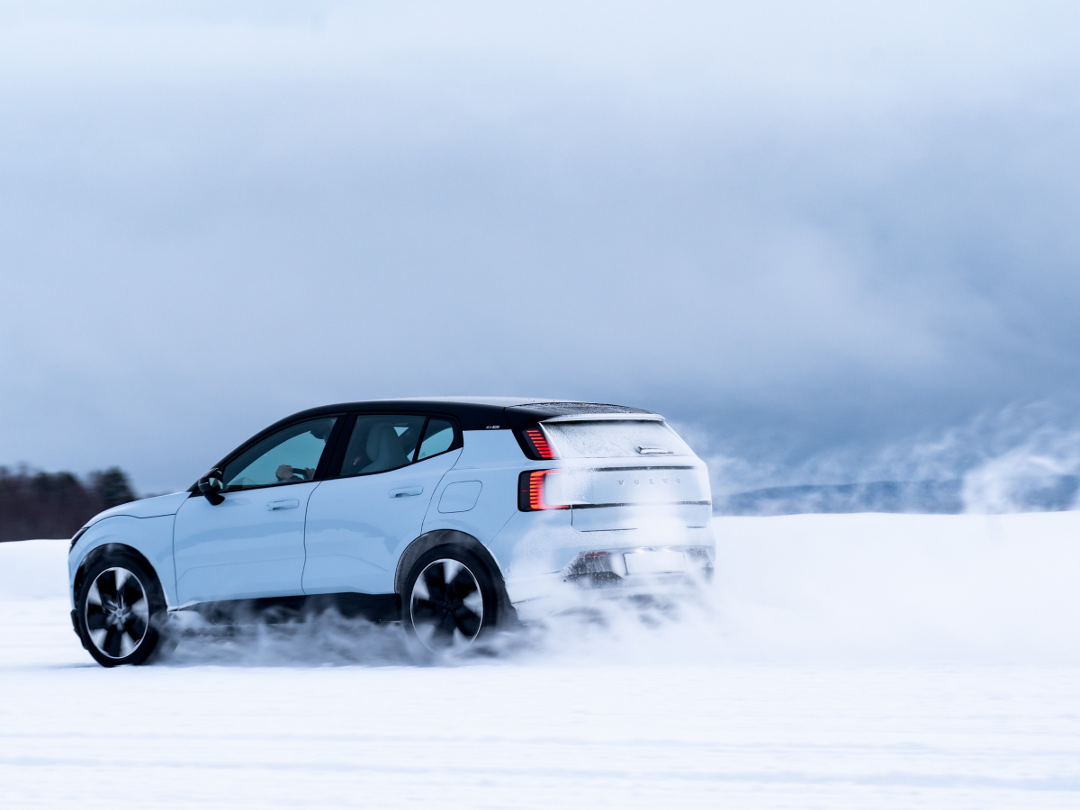 Rear three-quarter of a cold blue Volvo EX30