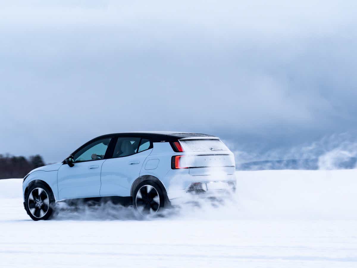 Rear three-quarter of a cold blue Volvo EX30