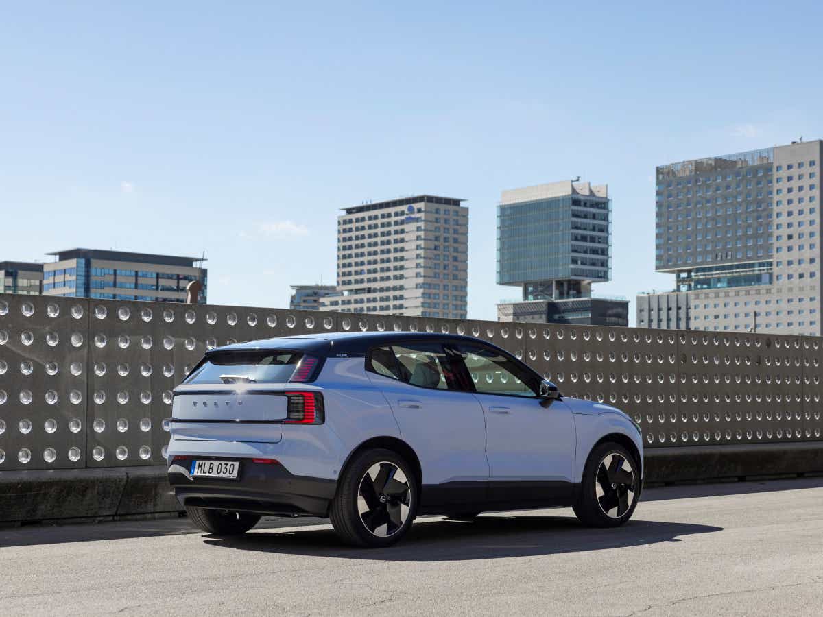 Rear three-quarter of a cold blue Volvo EX30