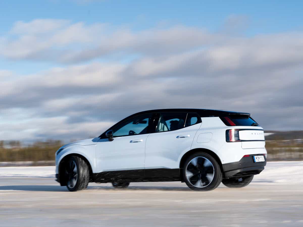 Rear three-quarter of a crystal white Volvo EX30