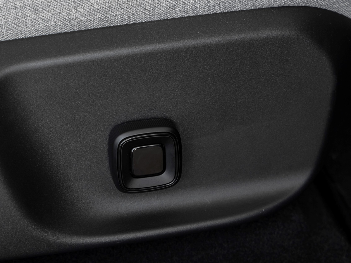 Close-up of seat adjustment button in a Volvo EX30