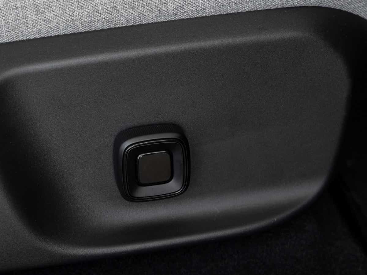 Close-up of seat adjustment button in a Volvo EX30