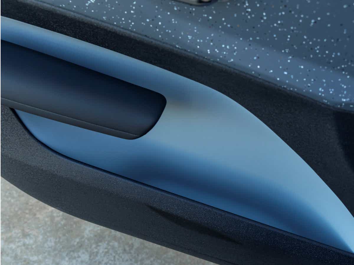 Close-up of the door trim of a cold blue Volvo EX30