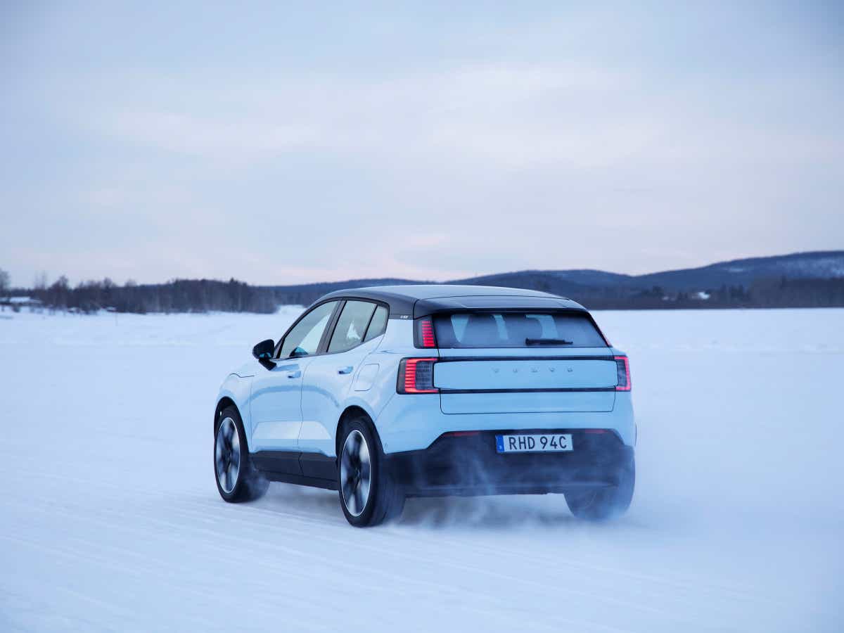 Rear three-quarter of a cold blue Volvo EX30
