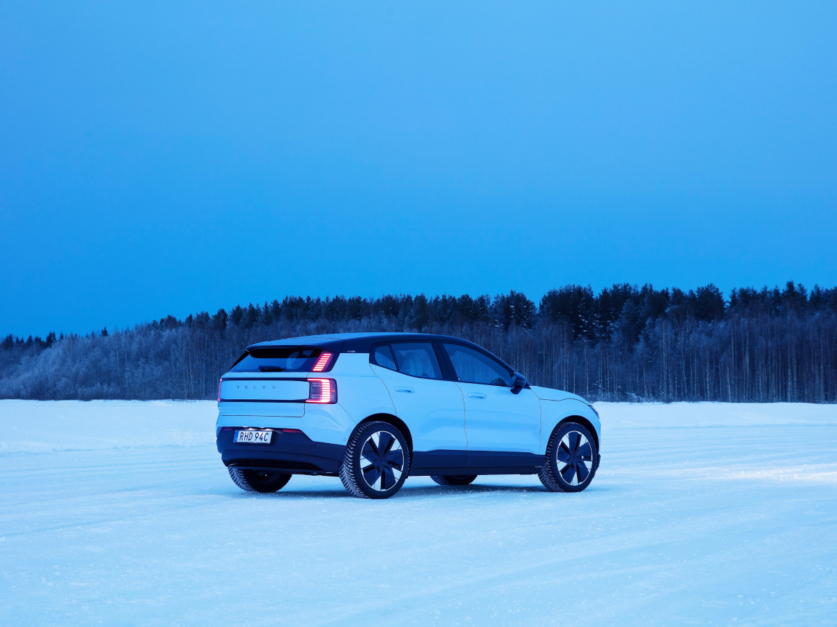 Rear three-quarter of a cold blue Volvo EX30