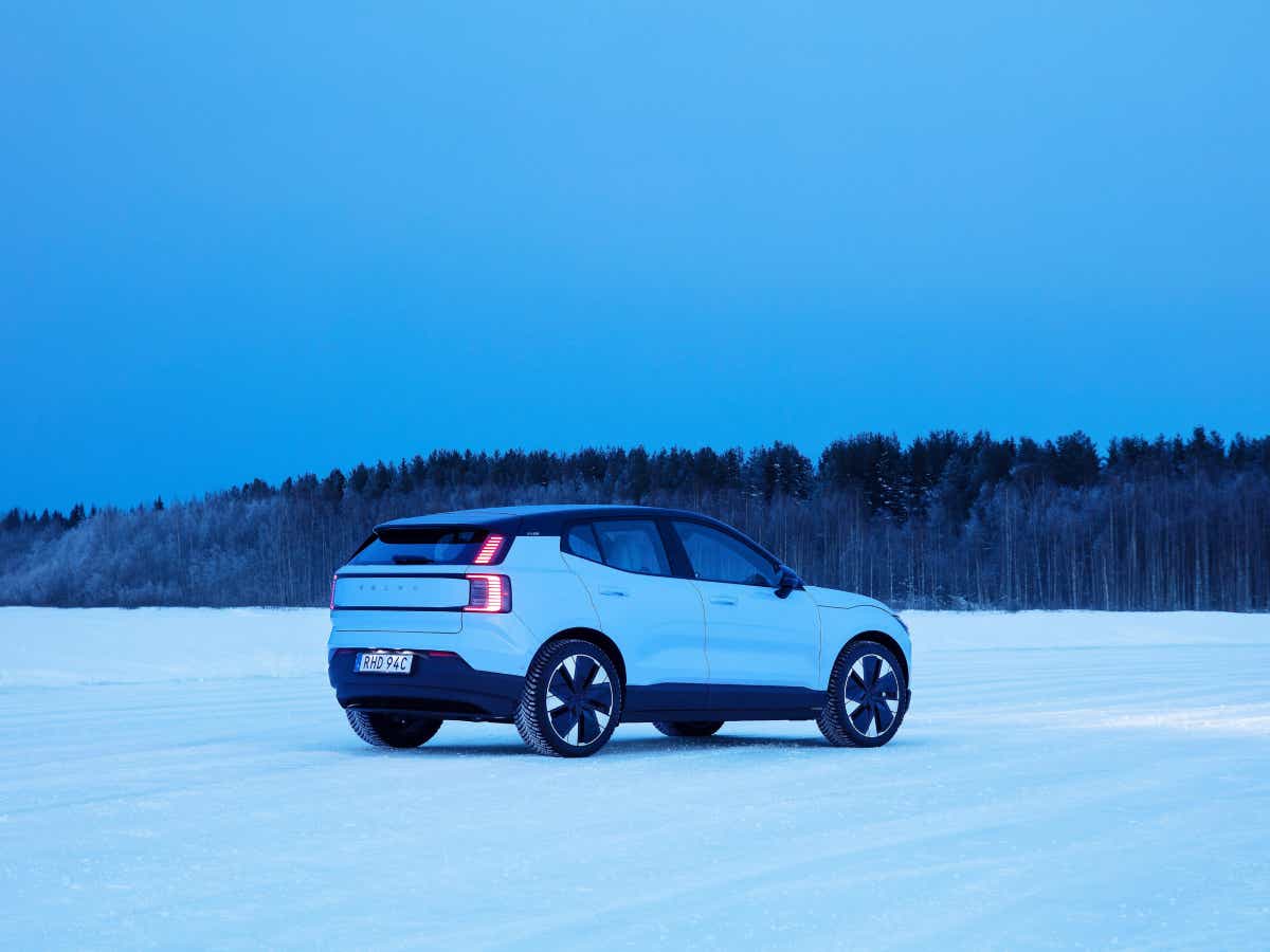 Rear three-quarter of a cold blue Volvo EX30