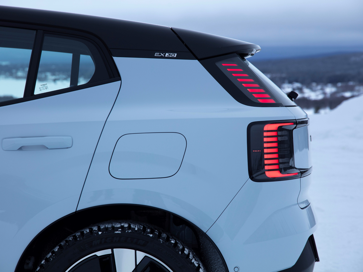 Rear three-quarter of a crystal white Volvo EX30