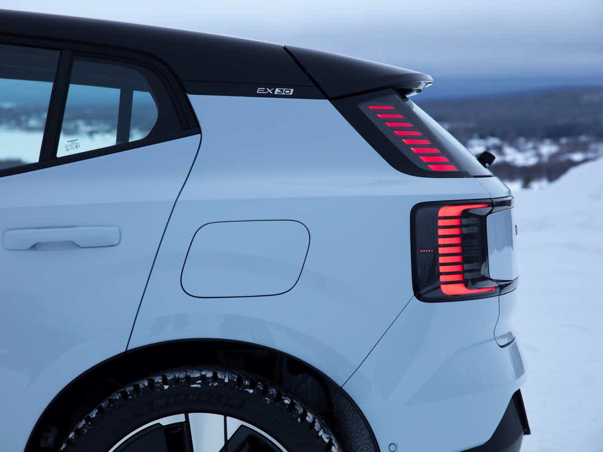 Rear three-quarter of a crystal white Volvo EX30